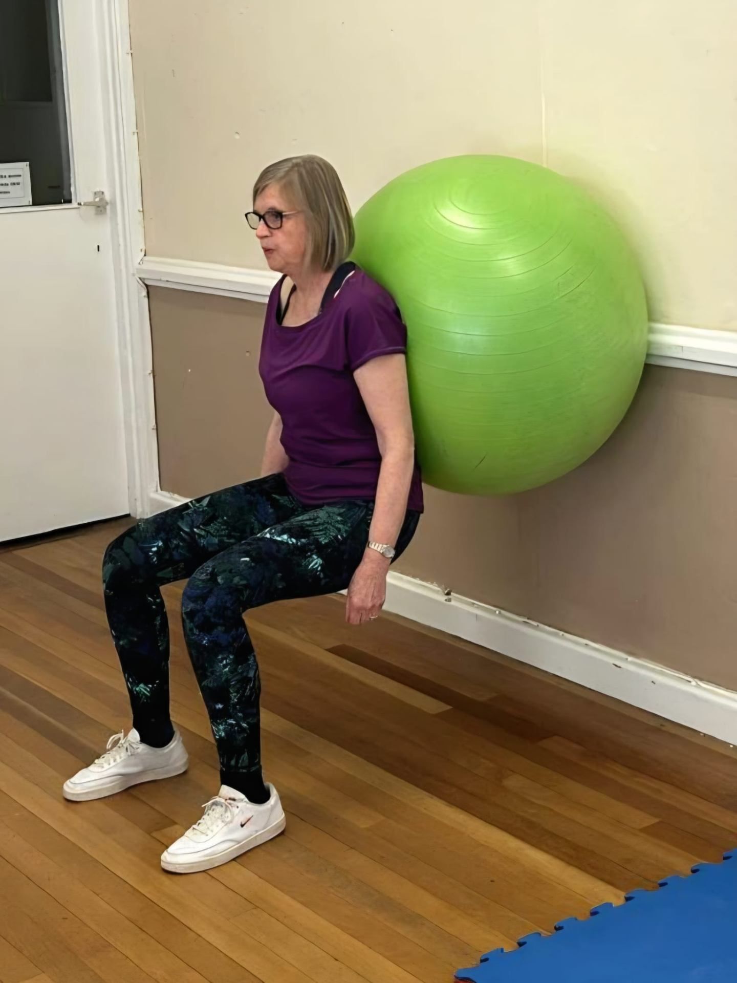 Participant performing a wall ball squat for lower-body strength
