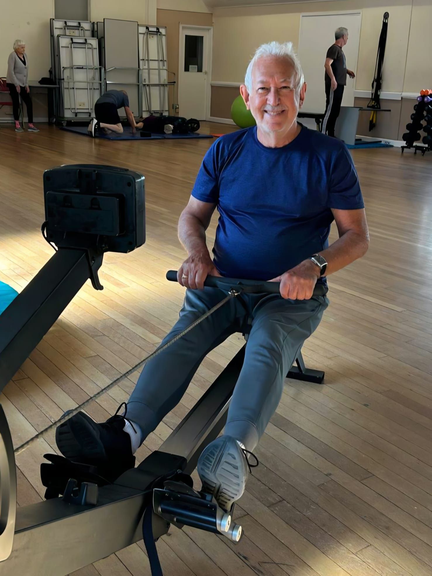Class participant exercising on a rowing machine