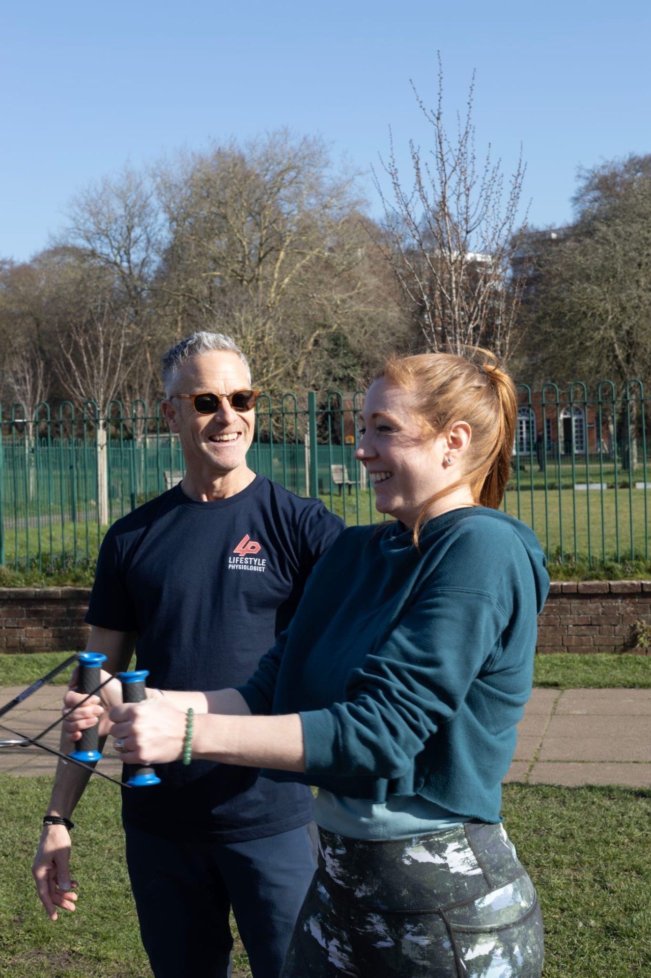 Richard coaching a client with resistance bands outdoors