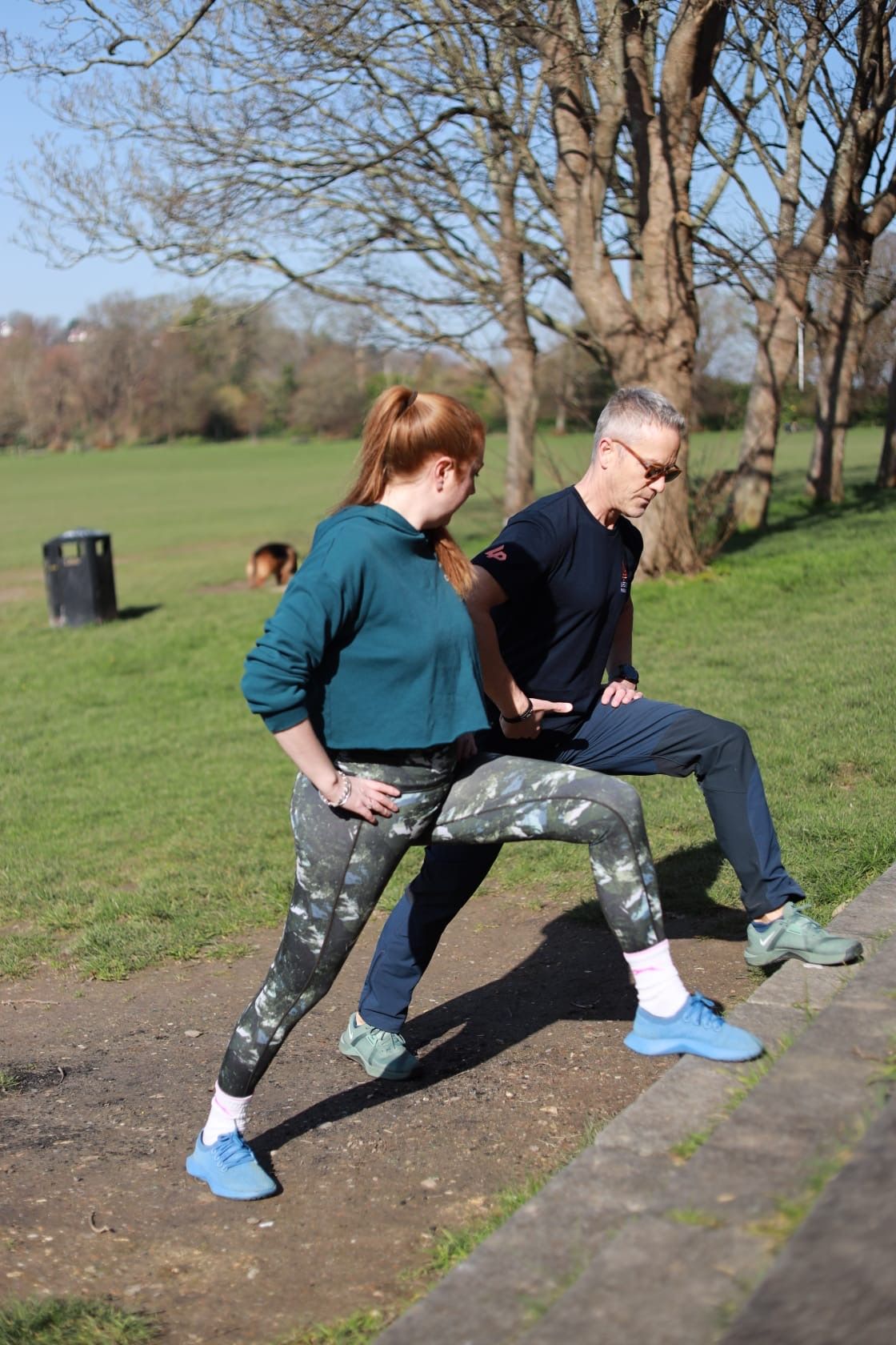 Richard coaching a client through lunges outdoors