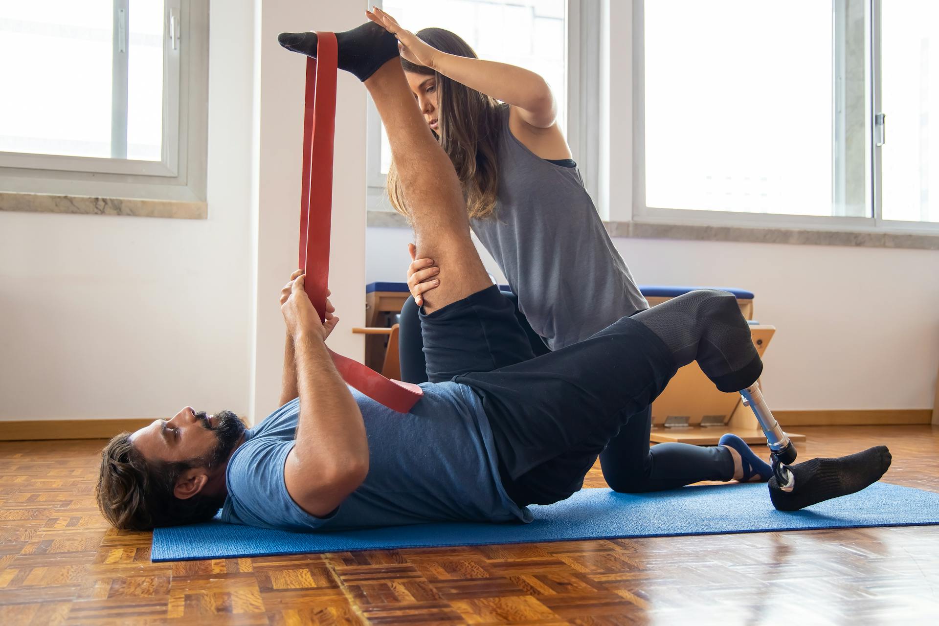 Man in rehabilitation exercises with a trainer